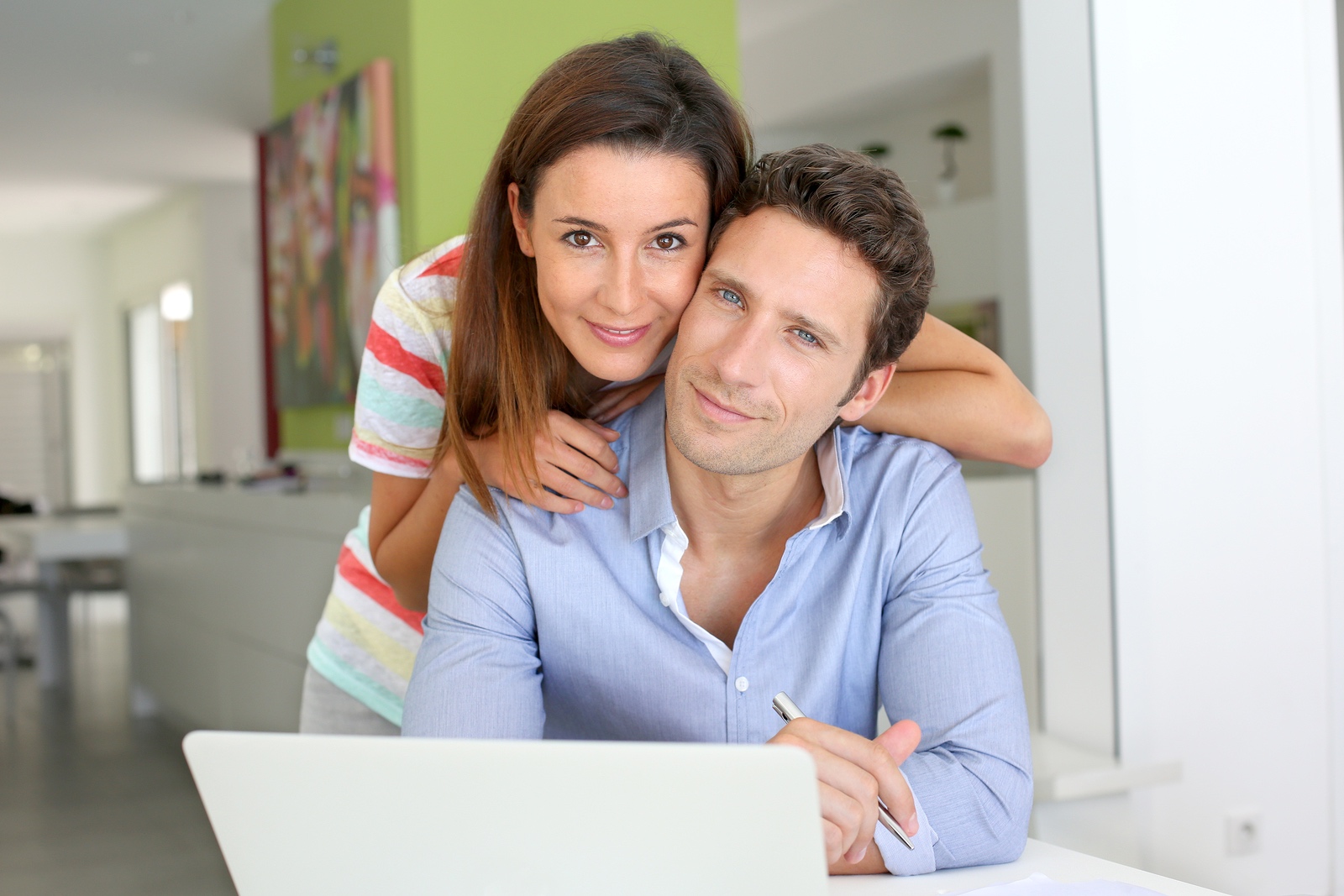 Couple at home looking at bank account on internet