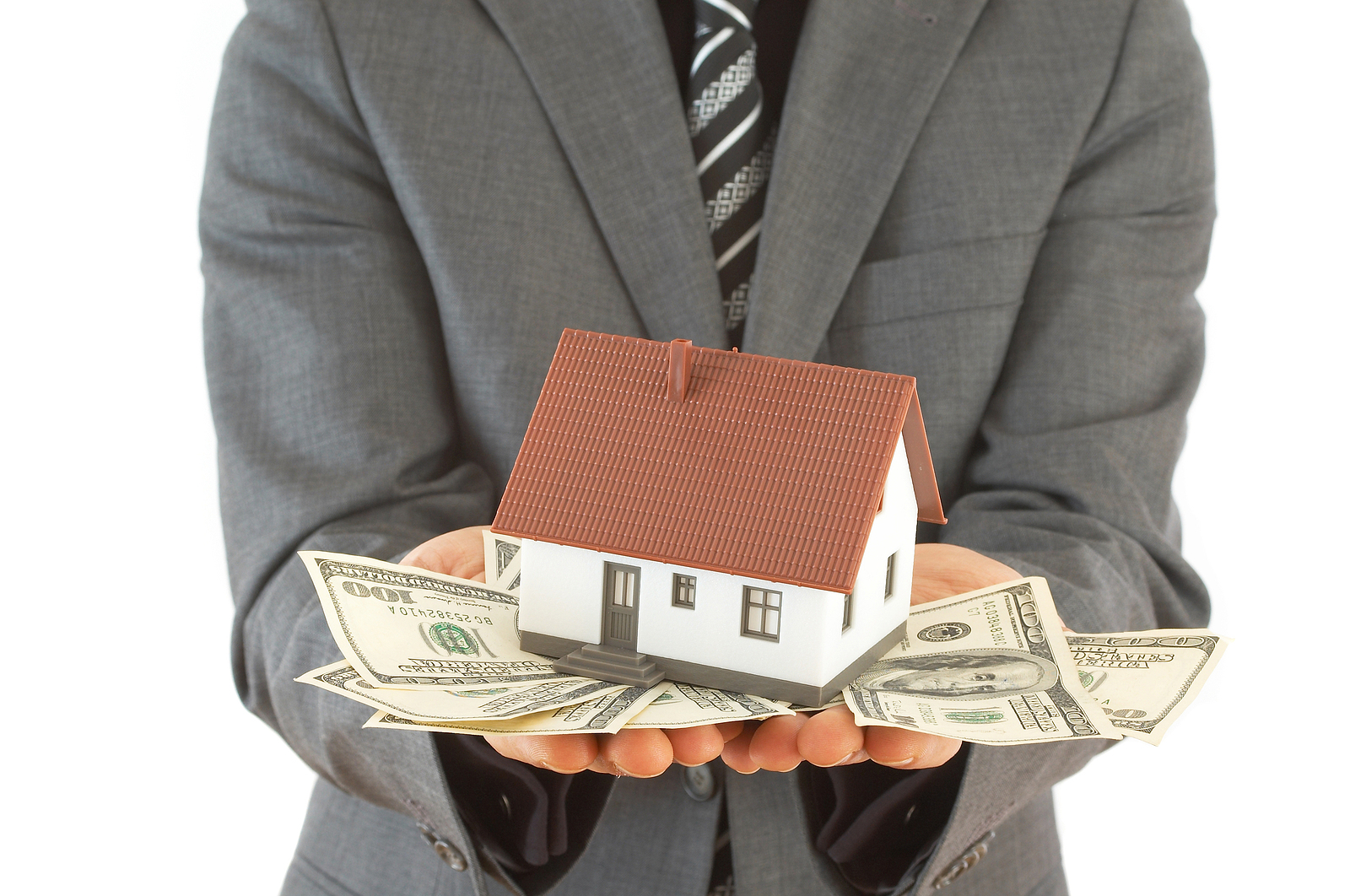 businessman with a house and US dollars for real estate concept
