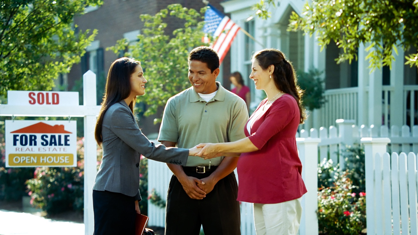 A young couple purchases a new home from a real estate agent.
