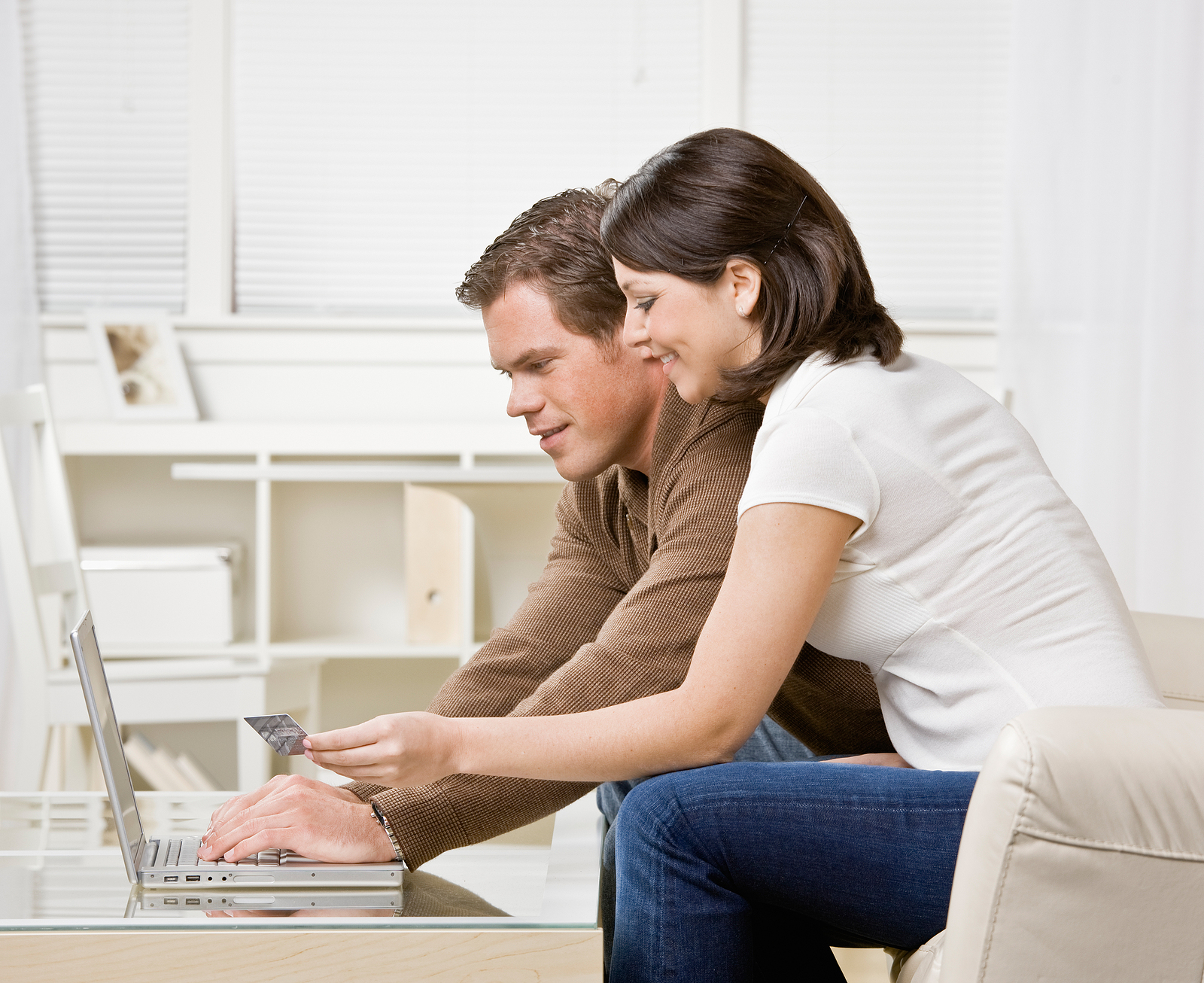Couple using credit card to shop online conveniently